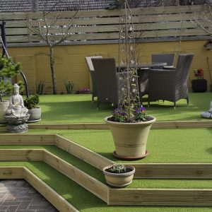 A stepped feature in a garden using fake turf.